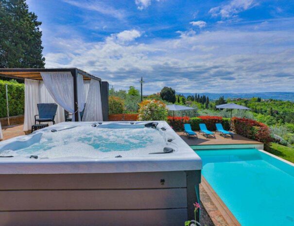 Villa Bellavista jacuzzi pool; gazebo with white shades; Chianti hills view - villa rentals by Timeless Tuscany tour operator