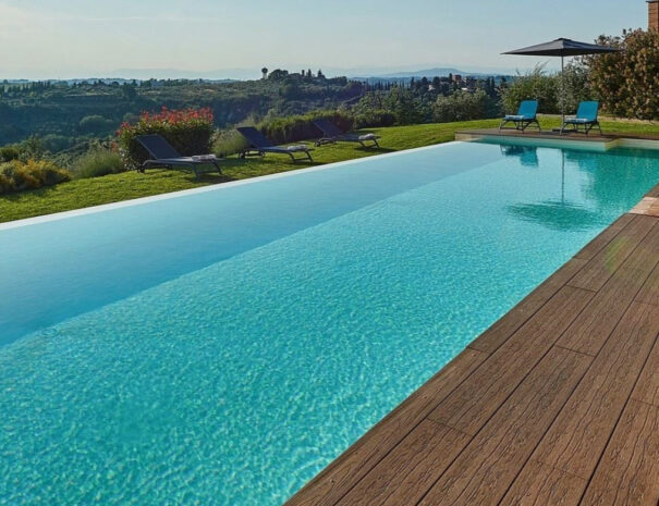 Villa Bellavista swimming pool; deck with lounge chair; Chianti hills view - villa rentals by Timeless Tuscany tour operator